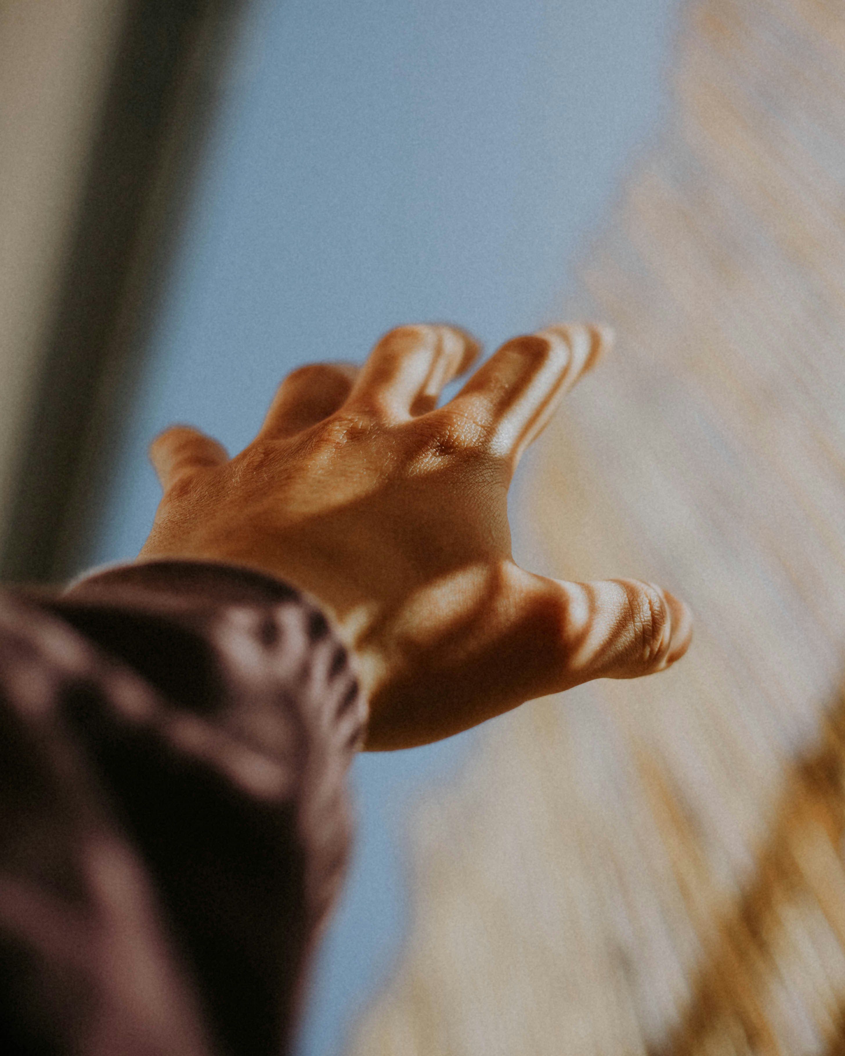 person in black pants raising right hand